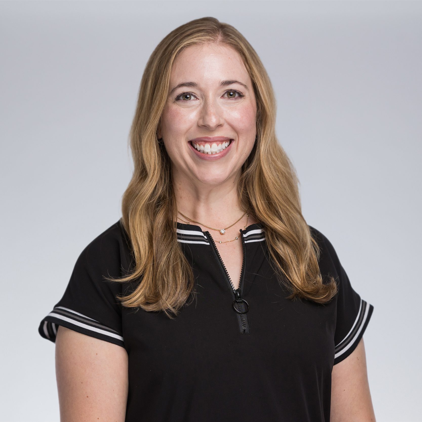 A diverse crowd of people celebrating at a concert, raising their hands and cheering.