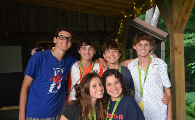Group of three smiling parents at a community event