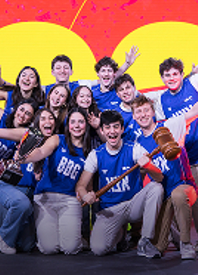 BBYO Centennial celebration with confetti, lights, and a crowd of attendees