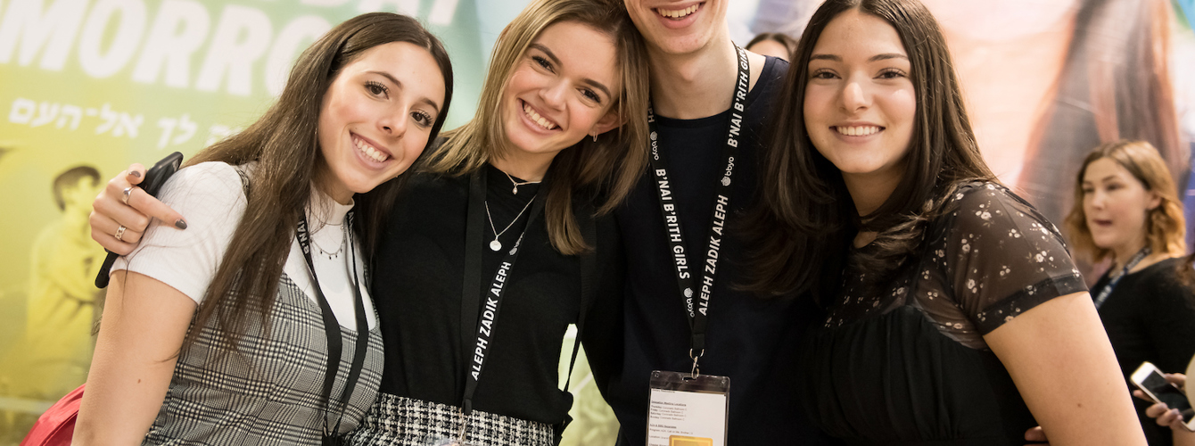 Group of diverse young people smiling at a community event