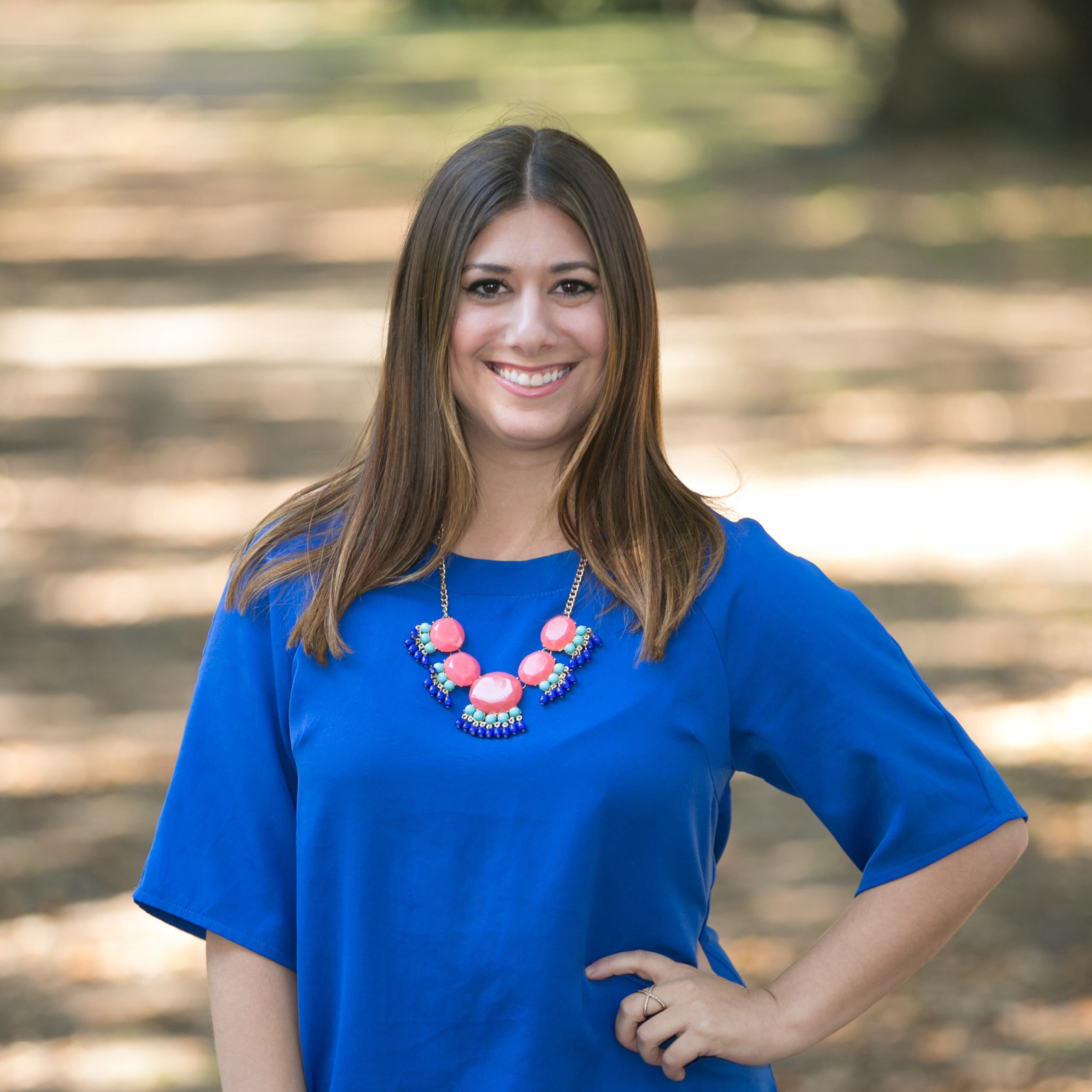A diverse crowd of people celebrating at a concert, raising their hands and cheering.