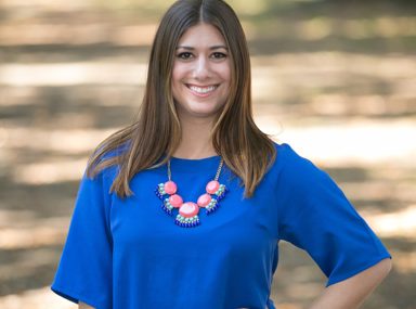 A diverse crowd of people celebrating at a concert, raising their hands and cheering.