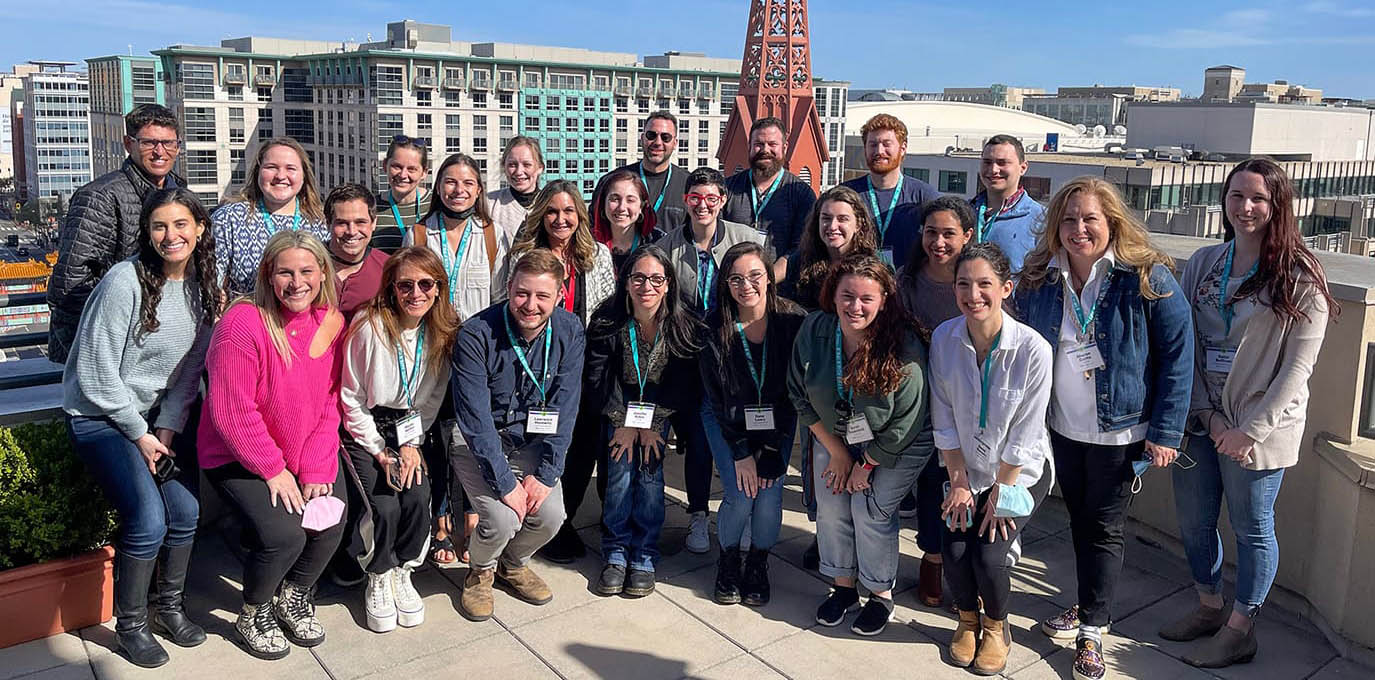 Group of diverse young people smiling at a community event