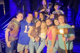 Group of people celebrating on stage